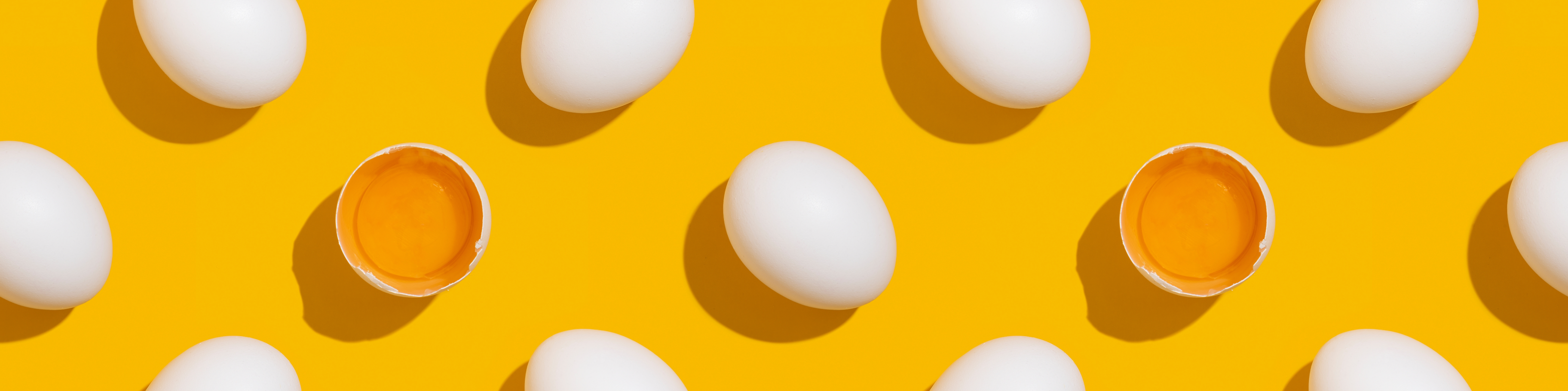Eggs scattered on a yellow background.