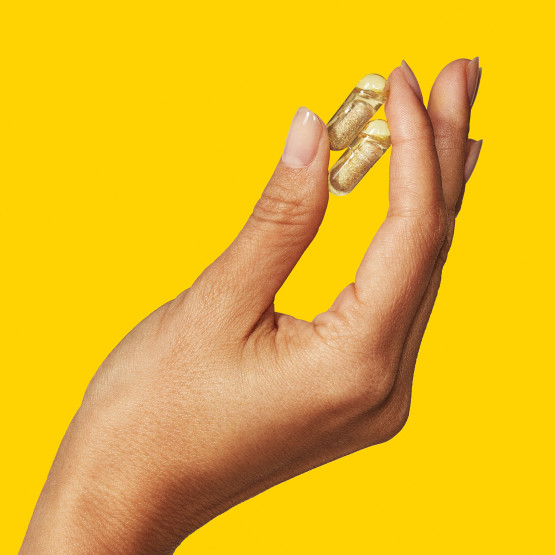 Woman's hand holding Ritual's Prenatal Multivitamin