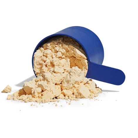 Protein scoop tilted over with protein powder spilling out of it