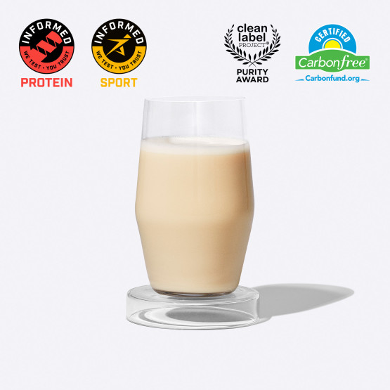 Glass of protein shake w/ Informed Protein, Informed Sport, Certified Carbon Free, and Clean Label Project Certified Badges