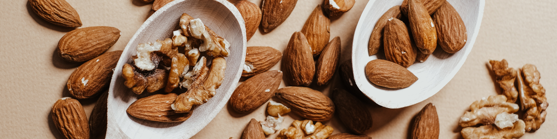 Spoonfuls of walnuts and almonds which are foods high in omega-3 dha.