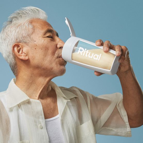Photo of a man's side profile drinking a protein shake from a Ritual branded shaker