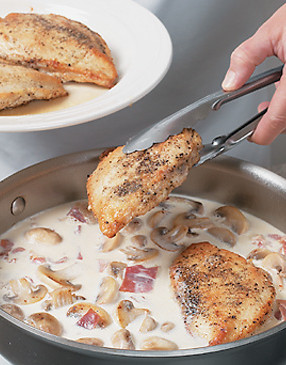 As the sauce thickens, return the chicken to the pan to finish cooking it.