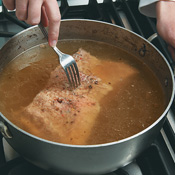 Simmer beef for several hours over low heat. The beef is ready when it easily shreds when pierced with a fork.