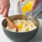 Add egg yolks only after potatoes have cooled slightly. Hot potatoes could curdle the yolks.