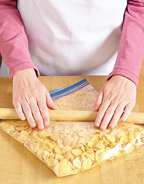 To easily make corn flake crumbs, add them to a resealable plastic bag and use a rolling pin to crush them.