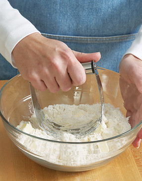It's easiest to cut butter into dry ingredients using a pastry blender. If you don't have one, use two table knives.