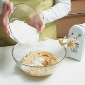 Blend the dry ingredients into the creamed mixture in two batches, mixing after each addition. 