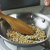 Stir pine nuts constantly, or they&rsquo;ll brown unevenly and burn.
