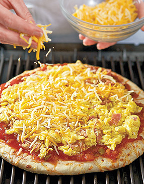 Top pizza with sauce, egg mixture, and cheese, then grill until crust browns and cheese melts. 