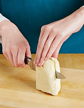 For the best smoky flavor, maximize the surface area of the cheese by halving it before grilling.