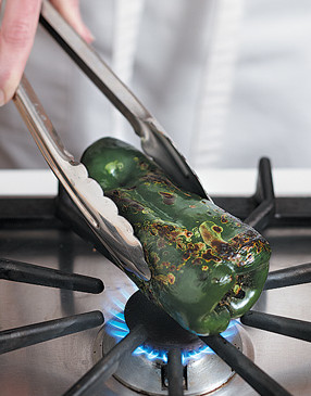 Use tongs to hold poblano over gas flame. Roast until charred, rotating often as it blackens.