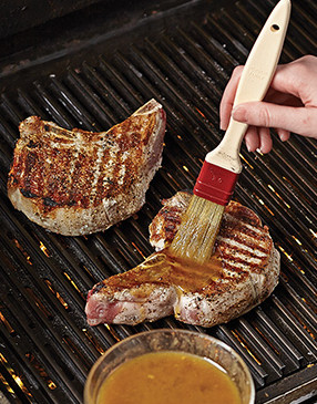 To help protect the chops from excessive charring, start glazing them halfway through grilling.