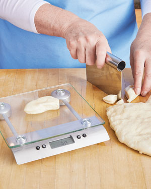 Cutting milk bread dough for clover leaf rolls