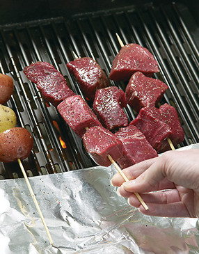 Position the handles of the skewers over the foil to prevent them from catching fire.