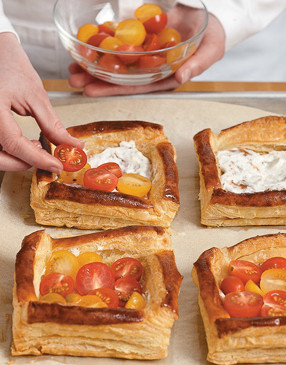 Spread goat cheese over centers of baked squares; top with tomatoes and return to oven for 5 minutes.
