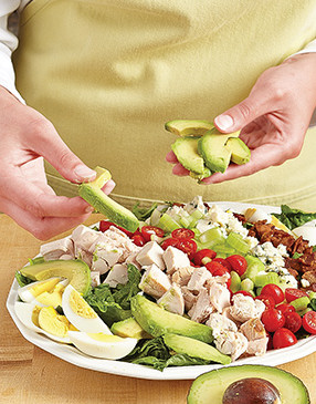 Slice the avocado just before adding it to the salad. Exposure to air causes it to oxidize and brown.
