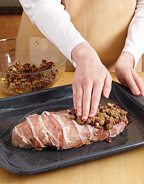 The stuffing should be sticky enough to stay put on the sides and ends of the breast when pressed.