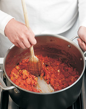 Even drained tomatoes can release a lot of liquid as they cook. Simmer until most of their juice evaporates.