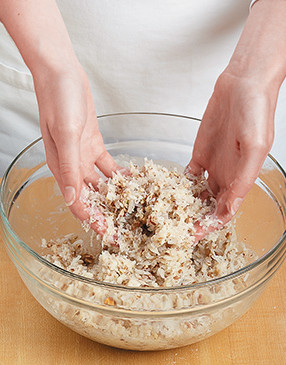 So the dry ingredients hold together, use your hands to thoroughly coat them with the egg white mixture.