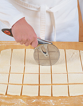 Cutting the dough into similar-sized pieces ensures they'll cook evenly and in the same amount of time.