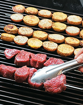 Potatoes and beef can cook at the same time when the grill is set for two-zone grilling.