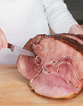 For easier serving, cut around the bone to help loosen the attached slices of ham.