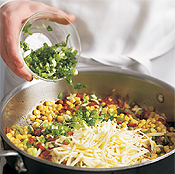 Mix bacon, chiles, Cheddar, and scallions with corn; chill before filling the empanadas.