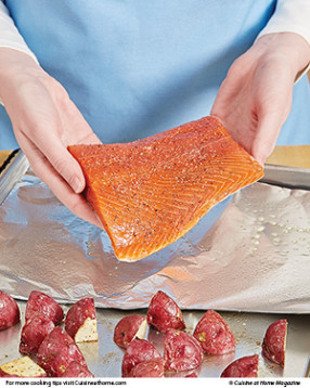 The potatoes take longer to cook, so start them first, flip them, then add the salmon and finish roasting. 
