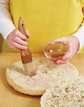 To add a zip of flavor that cuts through the meats and cheese, brush the focaccia with vinegar.