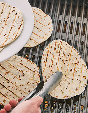 You just want to warm the tortillas so they’re pliable. When you see grill marks, they should be ready.