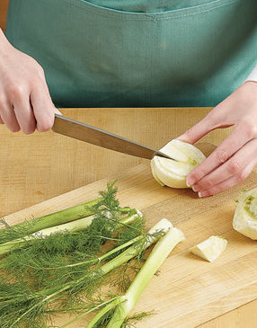 Once you’ve trimmed the stalks and root end, slice the fennel bulb in half, then remove the center core.
