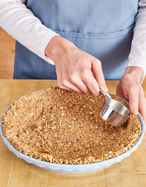 Firmly press the crumbs into the pie plate to ensure the crust holds together when slicing the pie.