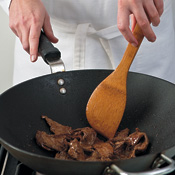 Stir-fry steak in two batches over high heat to quickly sear and caramelize it. Reserve the marinade for the sauce.