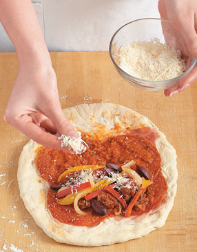 Mound meat and onion mixture on one side of calzone, leaving a 1-inch clean border at edge of dough.