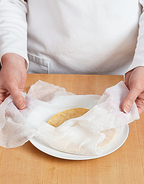 Heat tortillas in a damp paper towel in the microwave so they're pliable when filling and rolling them.