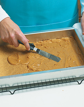 This peanut butter layer helps prevent the marshmallows from pulling away from the base as the bars are cut.