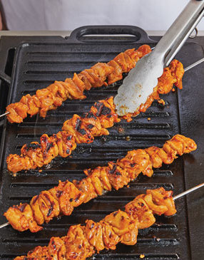 The skewers cook quickly on a hot grill. A good indicator the chicken is ready to flip is when it’s charred.