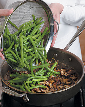 Add blanched beans to mushroom mixture. They're already cooked, so just heat them through.