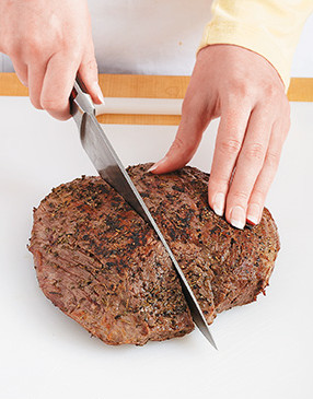 To make the steak easy to eat, first slice it in half with the grain, then slice it thinly against the grain.