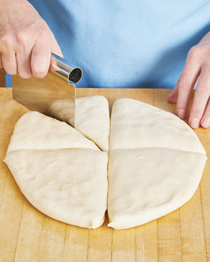 Cutting milk bread dough for dinner rolls