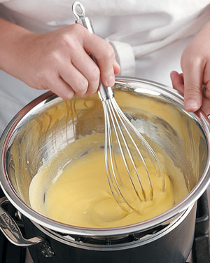 Gently cook and vigorously whisk the egg yolks until the whisk leaves trails in the thickened yolks.