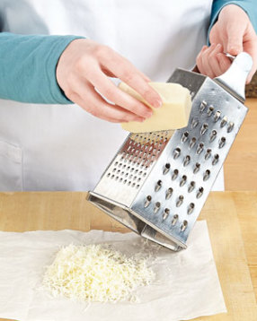 Finely shredding the queso fresco makes it easy to melt into the sauce. A box grater is the perfect tool.