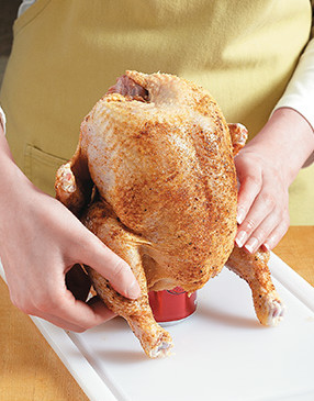 Once chicken is placed on the can, form the legs into a tripod to keep the chicken from tipping over.