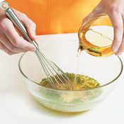 Drizzle the oil for the vinaigrette into the lemon mixture, whisking constantly until emulsified.