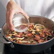 Add pasta water to kielbasa and vegetables; stir with a wooden spoon to scrape up any browned bits in the pan. 