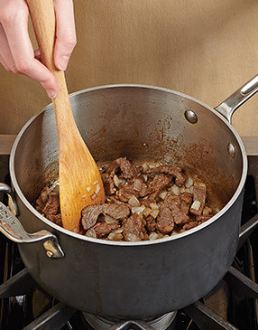 After browning the steak, add the onion so it softens and absorbs some of that beefy flavor.