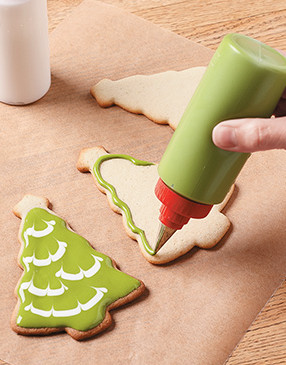Pipe a border of darker green icing around edges of cookie with a decorating squeeze bottle or disposable decorating bag.