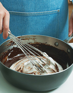 Whisk the beaten egg white into the chocolate mixture until there are no streaks.