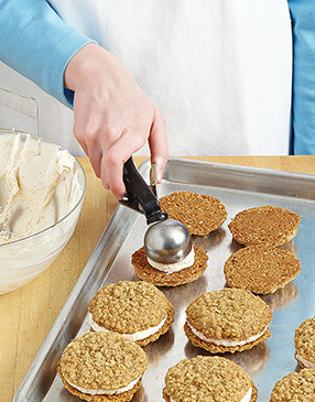 Using a large cookie scoop makes easy work of dividing the filling between half of the cookies. 